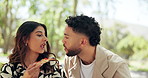 Eating, couple and picnic with pizza at park for outdoor date, bonding together and romantic kiss. Love, happy people and relax with lunch in nature for takeaway meal, hungry and relationship support