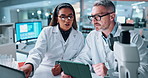 Scientist, people and study with tablet for microscope, chemistry testing and medical research. Biotech, laboratory and mentor with assistant for pharmaceutical comparison or pathology experiment