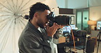 Man, flash and camera for photoshoot in studio for photography, shooting and production work. Photographer, equipment and lens for image capture, fashion magazine and creative industry professional