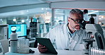 Microscope, science and tablet with man in lab for development of cure, medicine or treatment. Biotechnology, innovation and investigation with mature scientist in clinical trial for research