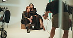 Photography, set and couple on chair in studio with production team for creative magazine. Fashion, equipment and photographer with influencers posing for portfolio photoshoot with art agency.