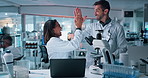 Science, laboratory and people high five with microscope for medical discovery, research and lab results. Healthcare, biotechnology and scientists on tablet for teamwork, breakthrough or vaccine cure