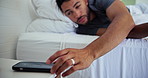 Man, phone and wake up with alarm in bed for start day, checking notifications and morning routine. Mobile, clock app and sound alert in home with social media scroll, reading online news and awake