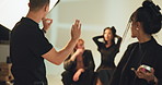 Photography, high five and planning with people in studio for success, creative director and backstage process. Okay sign, photoshoot and catalog achievement with makeup artist and editor for project