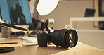 Photography, backstage and camera on desk in studio for magazine shooting, editing and creative catalog. Filming, production and photographer equipment on set for photoshoot, media and computer 
