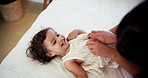 Love, mother and tickle baby on bed for bonding, playing games and child development in home. Above, woman and happy kid in bedroom with fun activity, funny and security with support, trust and care
