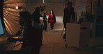 People, photographer and fashion photoshoot in studio, backstage prep, production process or shooting. Female stylist, model and bts with catalog of photography, beauty magazine and creative industry