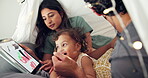 Tent, child and parents with tablet in home for educational app, streaming service and learning development. Fairy lights, people and bonding with baby in blanket fort for internet connection or love
