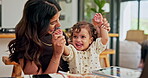 Remote work, baby and mother with smile, playing and bonding together in living room. Apartment, family or parent with kid on lap, tablet or network with multitasking, game or cheering with happiness