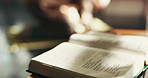 Person, prayer and closeup of Quran in home for blessing, worship and learning to praise Allah. Religious faith, spiritual teaching and open book for Islamic religion, education and praying for peace
