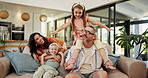 Parents, children and plane on shoulders, couch or playful with bonding, laugh and happy in lounge. Father, mother and daughter with games, excited or flight with love in living room at family home