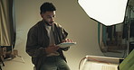 Man, check and tablet for photography in studio with photoshoot results, editing and catalog. Photographer, digital or retouch process in backstage to review picture, production and magazine industry