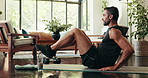 Health, fitness and man with sit ups in home for morning workout in living room with challenge. Sports, balance and person with training routine for core strengthening exercise on yoga mat in house.