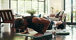 Health, sports and man with push ups in home for morning workout in living room with challenge. Fitness, balance and person with training routine for core strengthening exercise on yoga mat in house.