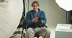 Face, lighting and photography with smile of man on set for fashion magazine or photoshoot. Camera, direction or production with happy photographer behind the scenes for artistic or creative catalog