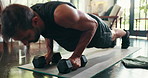 Weights, fitness and man with push ups in home for morning workout in living room with challenge. Sports, dumbbells and person with training routine for core strengthening exercise on mat in house.