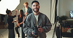 Face, photographer and smile with happy man on set for fashion magazine or style photoshoot. Camera, direction or production with person behind the scenes for artistic or creative photography catalog