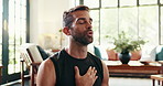 Breathing, meditation and namaste with man in living room of home for balance or inner peace. Fitness, mindfulness and yoga with calm person in apartment for awareness or mental health exercise