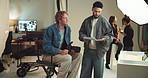 Camera, conversation and tablet with photographers on set for fashion magazine or style photoshoot. Direction, planning or production with people behind the scenes for artistic or creative catalog