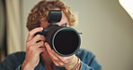 Camera, lens and photographer man on set for behind the scenes photoshoot or production. Catalog, lighting and magazine with person in professional photography studio for artistic or creative process