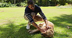 Man, dog and rub with love in nature for walk, run or game of fetch break at outdoor park. Male person, owner and pet or Labrador animal with touch for reward, support or care in forest for training