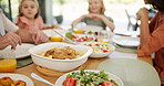 Dining table, food and plate for family in house for holiday, event or reunion with celebration at Easter. Hands, people and conversation with kids, meal or diet for nutrition with lunch at apartment