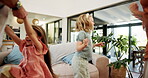 Dance, energy and bonding with family in living room for support, love and care. Happiness, teaching and trust with mother and children in lounge of home for jumping, music and smile together
