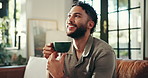 Home, sofa and man with coffee for thinking, espresso and comfortable on weekend in living room. House, happy person and blow in morning for hot cappuccino, beverage and relax with thoughts on couch