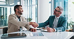 Happy, businessmen and meeting with handshake for business opportunity, deal or proposal at office desk. Male people, colleagues or coworkers shaking hands with smile for b2b, partnership or teamwork