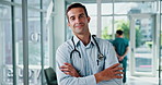 Face, doctor and happy man in hospital with arms crossed for healthcare service, medicine and wellness. Medical professional, cardiologist and portrait of worker, coworking and confidence in clinic