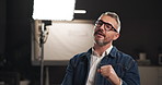 Talkshow, interview and man on set for filming with documentary, press or movie in studio. Recording, discussion and male journalist by lights for television public speaking with production equipment