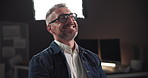 Talking, interview and man laughing on set for filming with documentary, show or movie in studio. Recording, discussion and journalist by lights for TV public speaking with production equipment.
