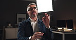 Talking, interview and man on set for recording with documentary, show or movie in studio. Filming, discussion and male journalist by lights for television public speaking with production equipment.