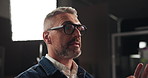 Talking, interview and man in studio for filming with documentary, show or movie on set. Recording, discussion and male journalist by lights for television public speaking with production equipment.
