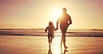 Father, child and running with sunset for beach travel, bonding together and summer vacation. Family, holding hands and fun energy with playful games, tropical holiday and exploring for getaway trip