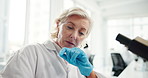 Mature woman, microscope and scientist at lab, notes and review with medical breakthrough. Person, tools and lens with zoom, bacteria and problem solving for virus, pharmaceutical or bird flu vaccine