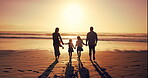 Family, sunset and walk by holding hands at beach for summer vacation, travel trip and bonding together. Back, parents and children on ocean for tropical holiday, weekend journey and nature adventure