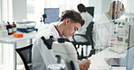 Science, lab and research with man, writing and microscope data analysis for report notes. Biotechnology, scientist and medical journal study with feedback and professional with healthcare article