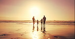 Parents, kids and sunset by holding hands at beach of summer vacation, travel trip and bonding together. Back, family and children walking on ocean for tropical holiday, weekend journey and adventure