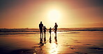Family, sunset and holding hands with children at beach for summer vacation, travel trip and bonding. Back, parents and walking with kids on ocean for tropical holiday, weekend journey and adventure