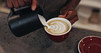 Man, barista hands and coffee art in cafe, hospitality service and ceramic presentation with milk. Beverage, creative process and latte culture in restaurant, waiter and pattern shape in bistro