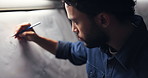 Man, drawing and paper for car design in montage, workshop or editing process for deadline at night. Person, hands and canvas for sketch, electric vehicle or transport with wheel in studio at company