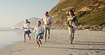 Family, kids and run for fun on beach with racing game, energy and bonding of summer vacation. Parents, children and playful with ocean activity, tropical holiday and travel adventure of getaway trip