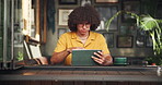 Coffee shop, student and man on tablet for online project, digital learning and research for assignment. University, restaurant and person on tech for website, internet search and studying in cafe