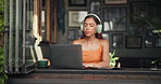 Girl, student and headphones with laptop at coffee shop, writing and notes for virtual class in morning. Woman, person and e learning with computer, study or notebook for education with drink at cafe