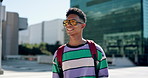 Football, thinking and youth with man on college campus for sports scholarship, education and future. Happy, university and gen z with person and walking in city for knowledge, academy and idea