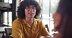Couple, happy man and date at cafe, talk and relax with funny memory, listen and bonding at lunch. Person, partner and smile with conversation, chat and care with love, drinks or tea at restaurant