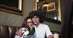 Love, gift and couple hug with flowers for valentines day celebration, romance or connection with partner. Man, woman and embrace with bouquet for present, smile or date for anniversary in restaurant