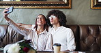 Selfie, pout and couple in restaurant together for love, romance or anniversary celebration. Photograph, smile and bonding with man, woman and flowers for valentines day date for social media