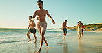 Vacation, people and friends running at ocean for freedom, travel or excited for adventure. Outdoor, water and group at beach for holiday, follow and students jump with energy to celebrate gap year
